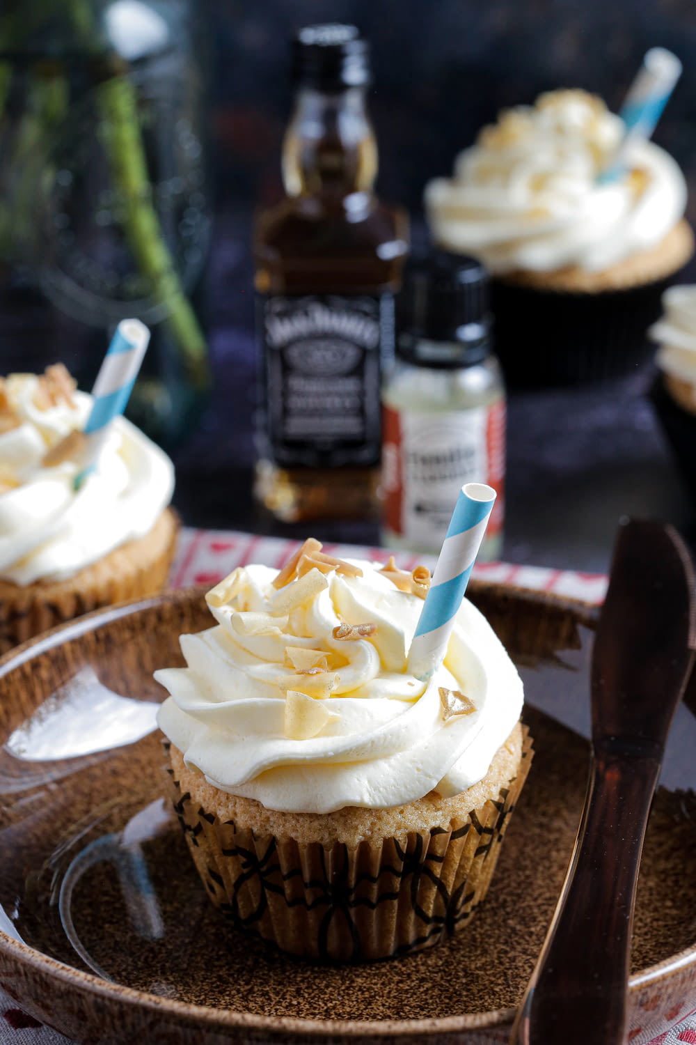 cupcakes with frosting on a plate with a spoon