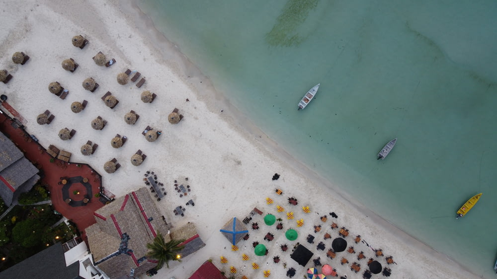 an aerial view of a beach with a lot of tables and chairs