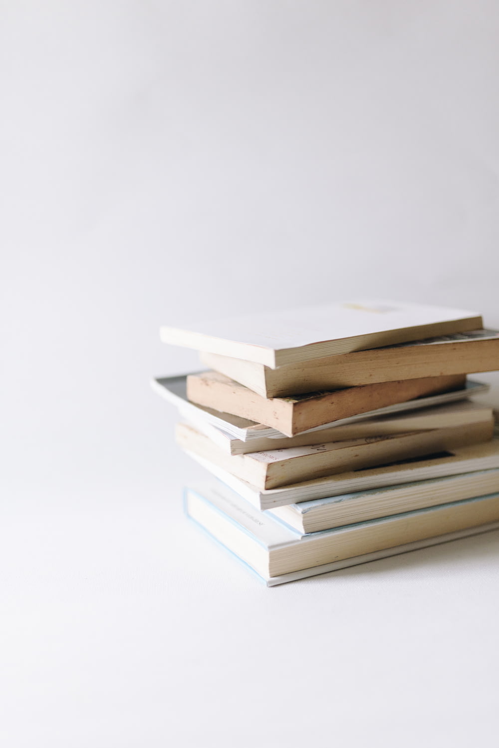 stack of books on white surface