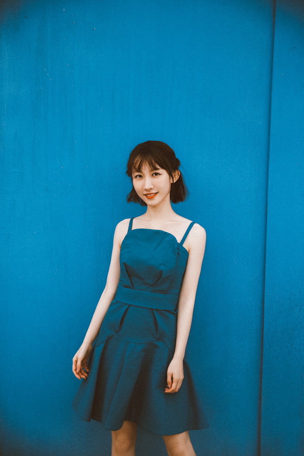 woman in blue sleeveless dress
