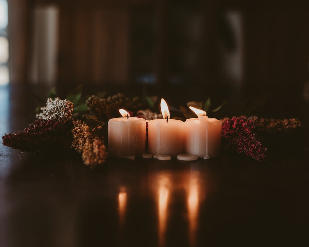white candles on brown wooden table