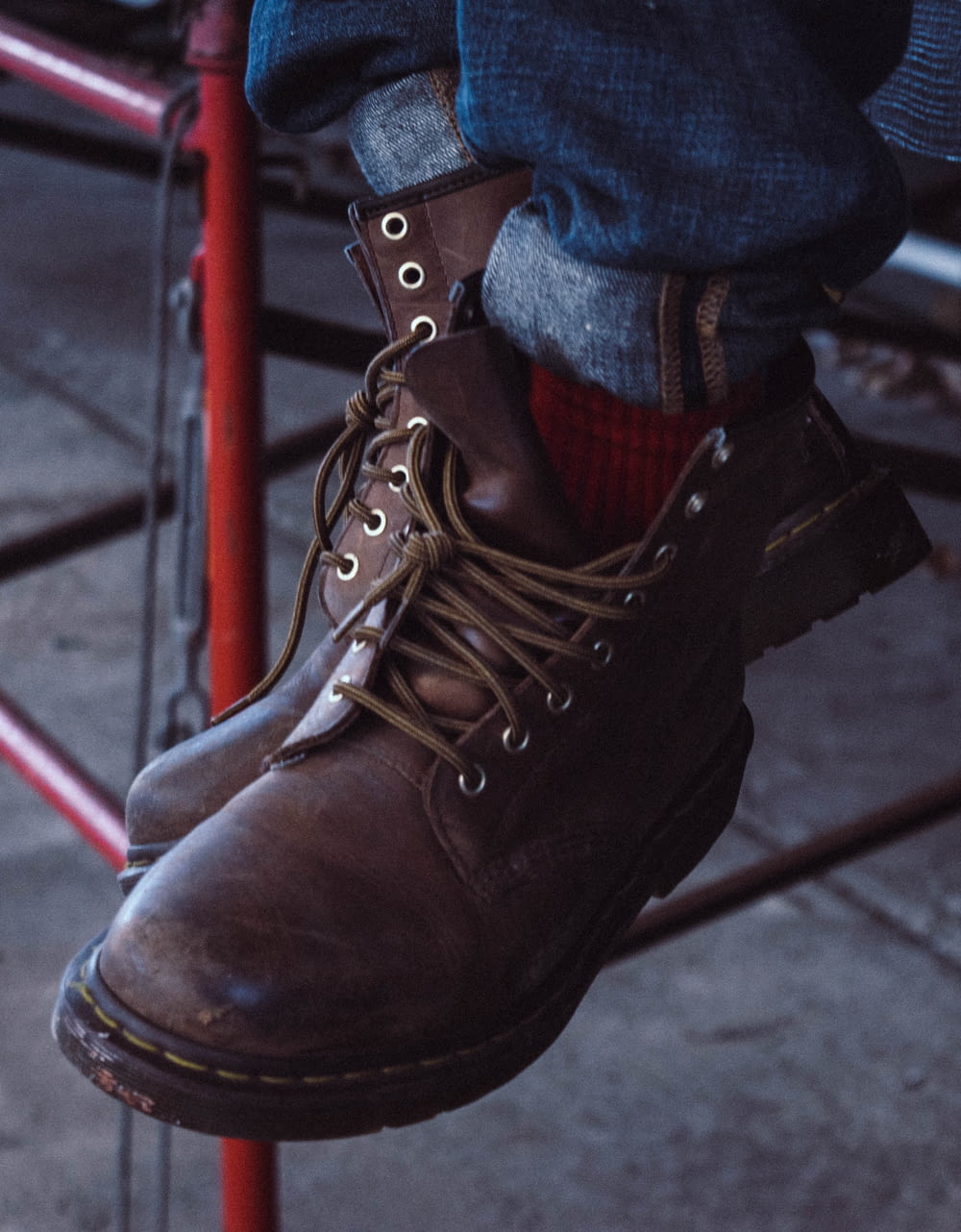 person wearing brown leather boots