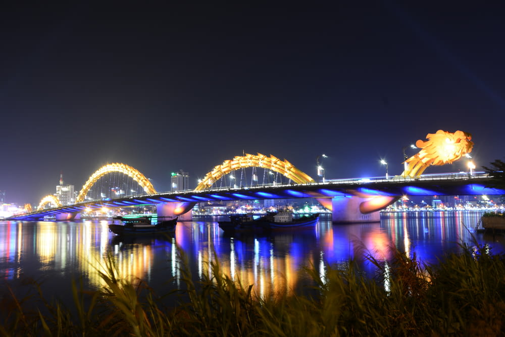 lighted bridge over river during night time