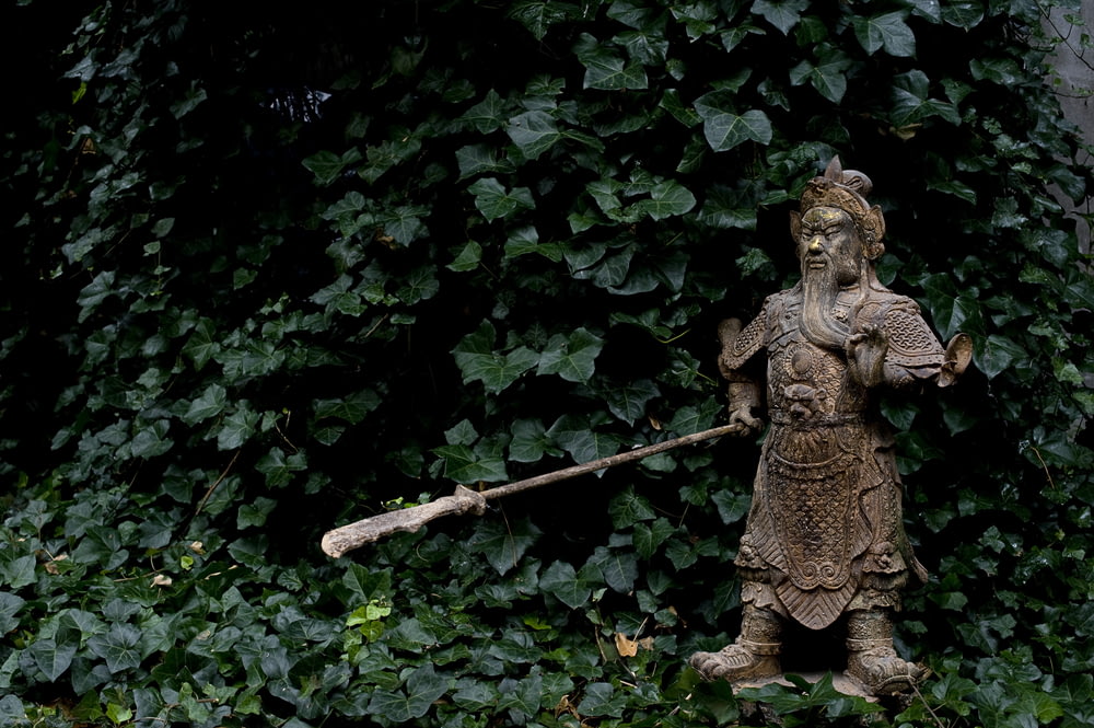 brown ceramic angel figurine on green leaves