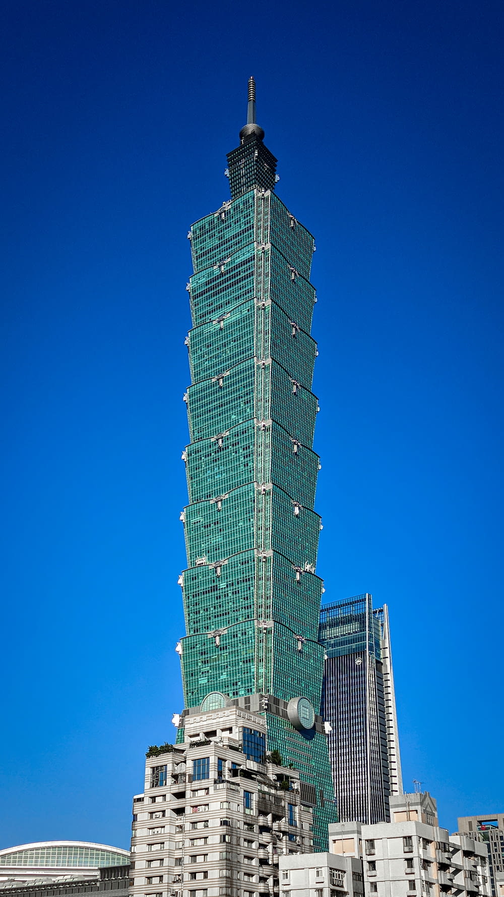 green and white high rise building under blue sky during daytime