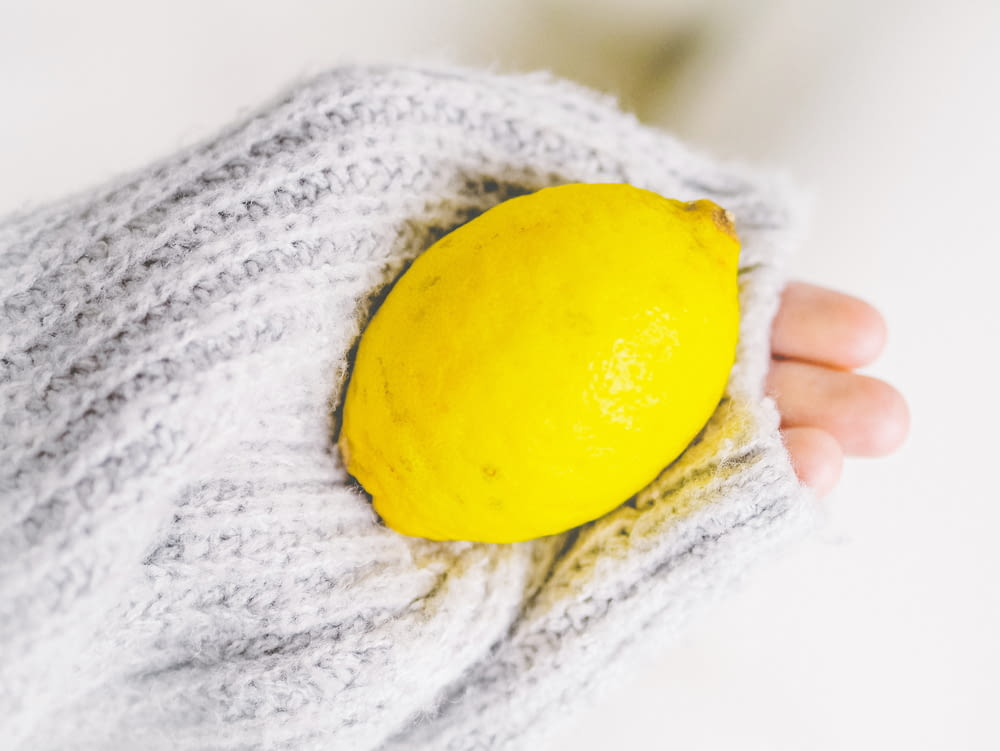 yellow lemon on white knit textile