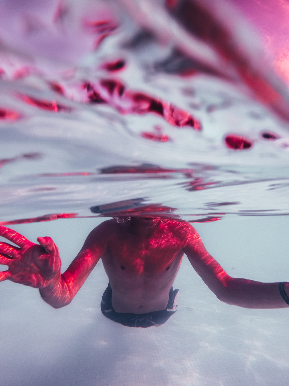person in water with red paint