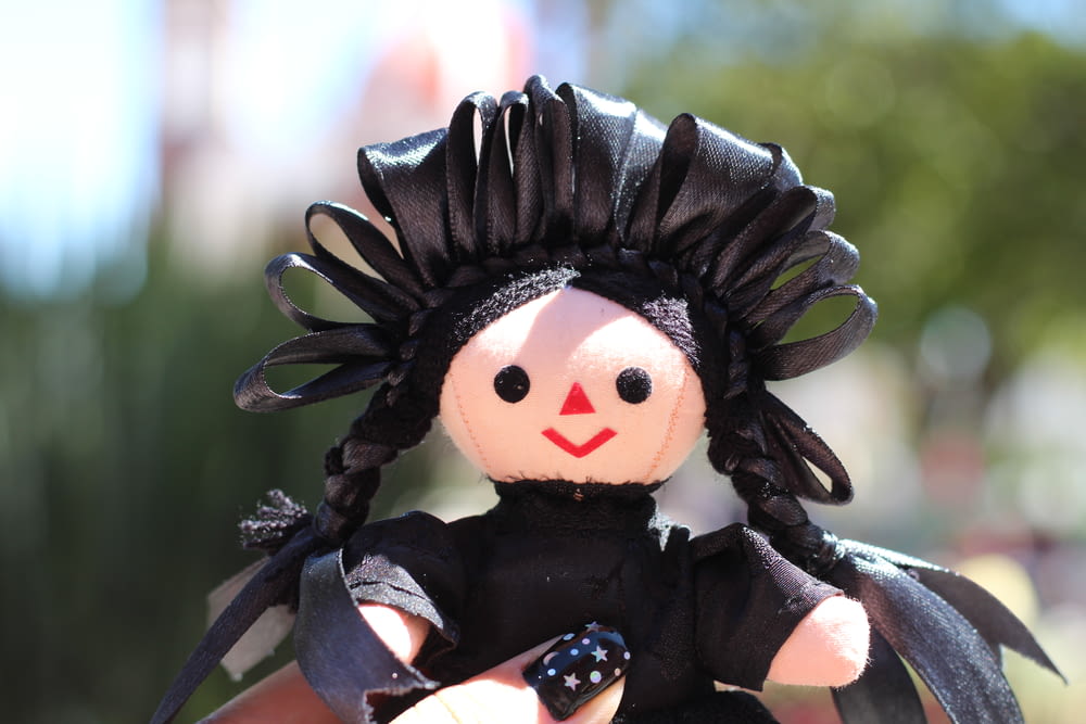 black haired girl in black and white dress doll