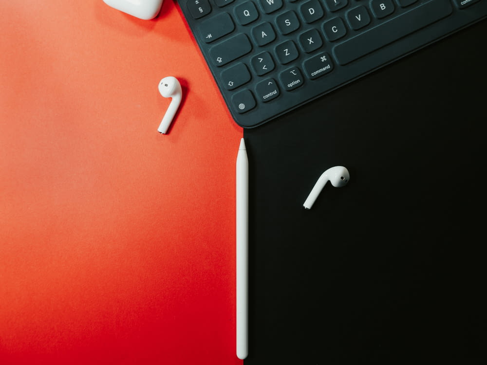 white earbuds on black laptop computer