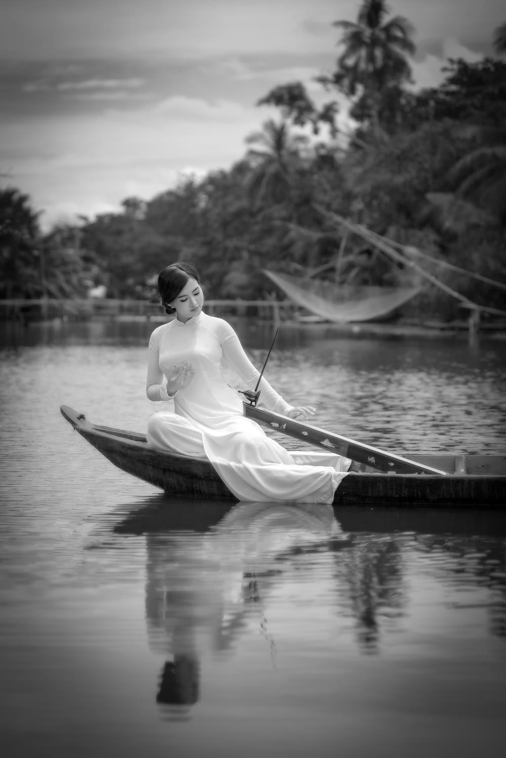 grayscale photo of woman in white shirt riding on boat