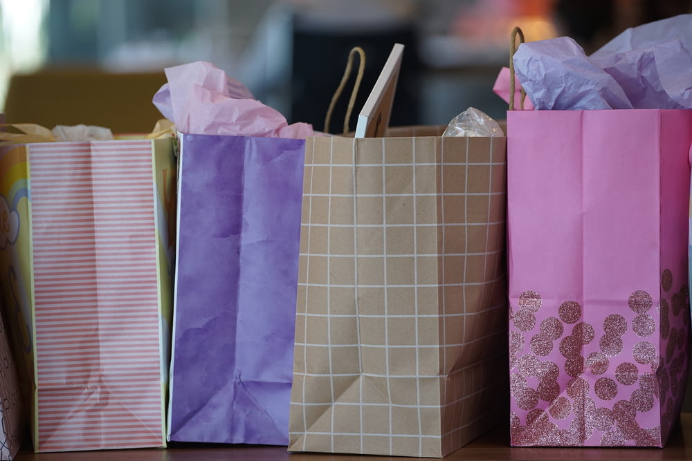 purple and white paper bags