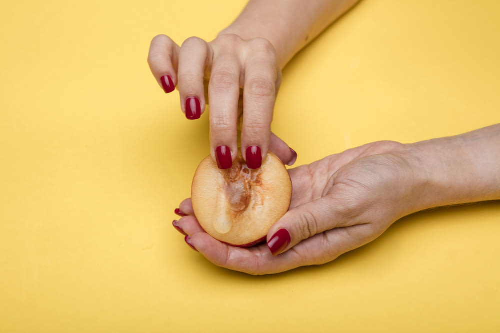 person holding a sliced of apple