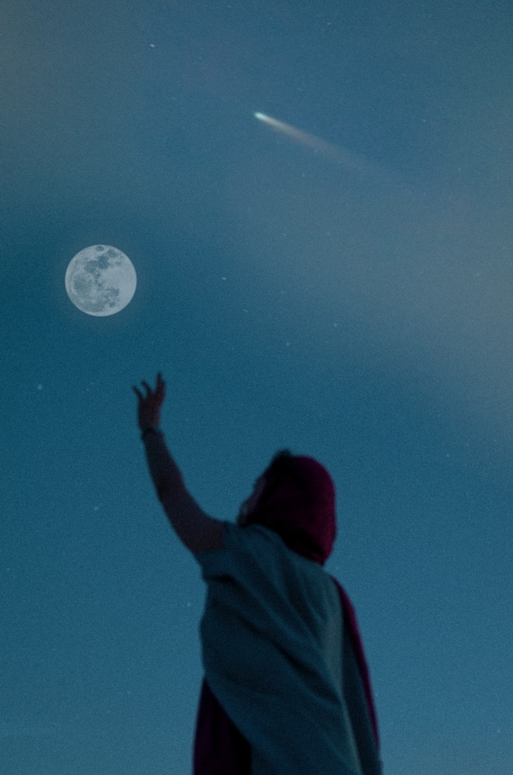 person in red hoodie looking at moon