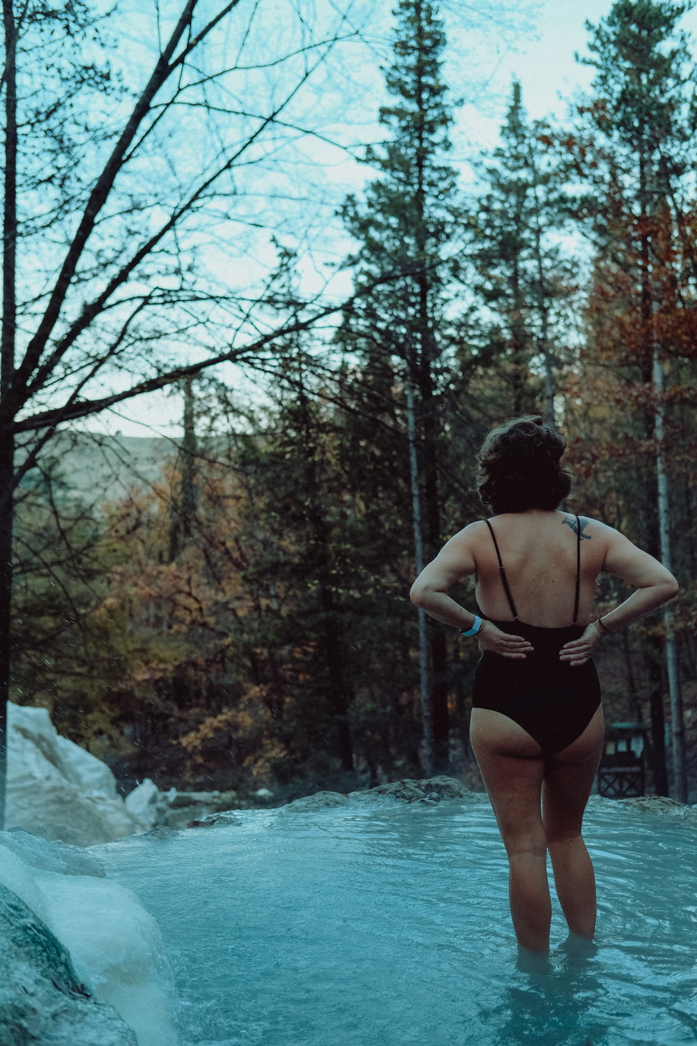 woman in black bikini standing on water