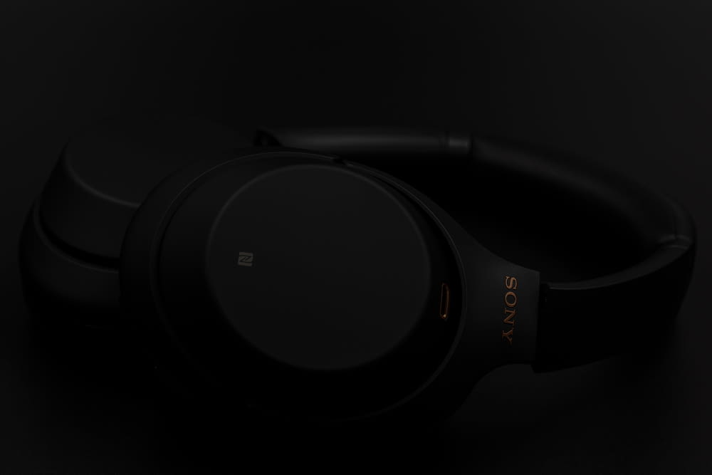 black and gray headphones on white surface