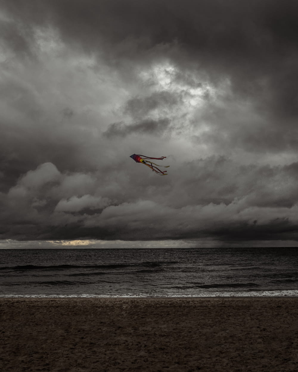 person surfing on sea under cloudy sky during daytime