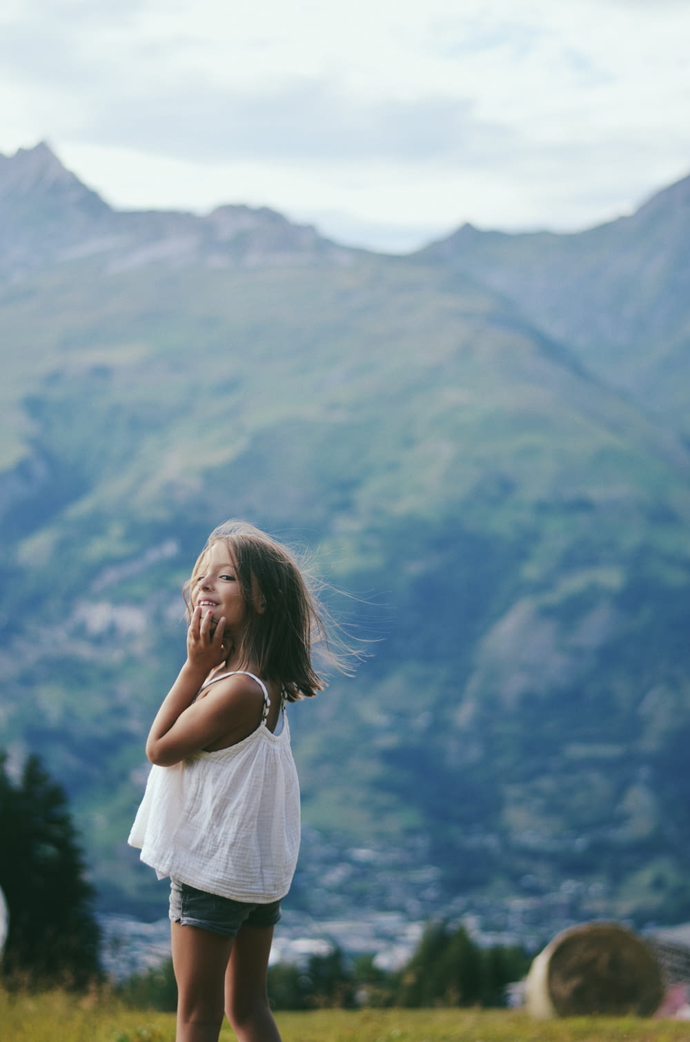 woman in white dress standing on top of mountain during daytime