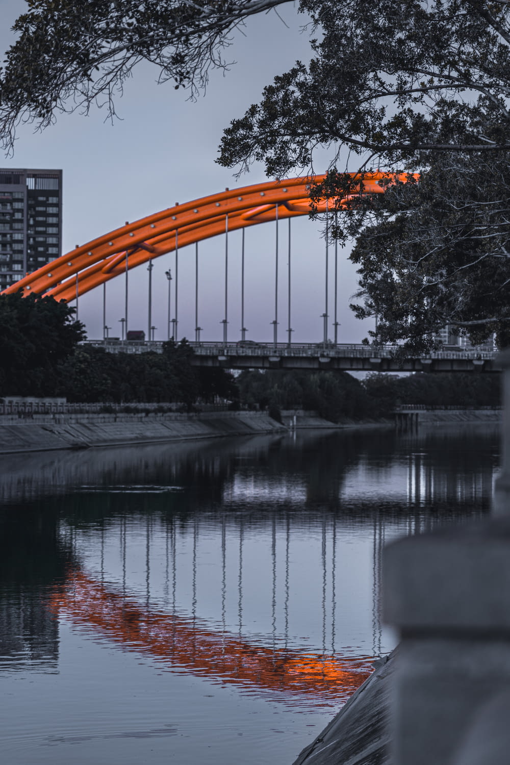 orange and black bridge over river