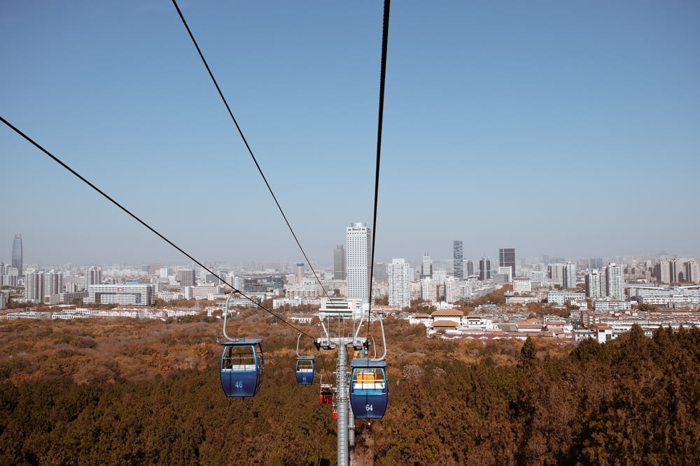 cable cars over city buildings during daytime