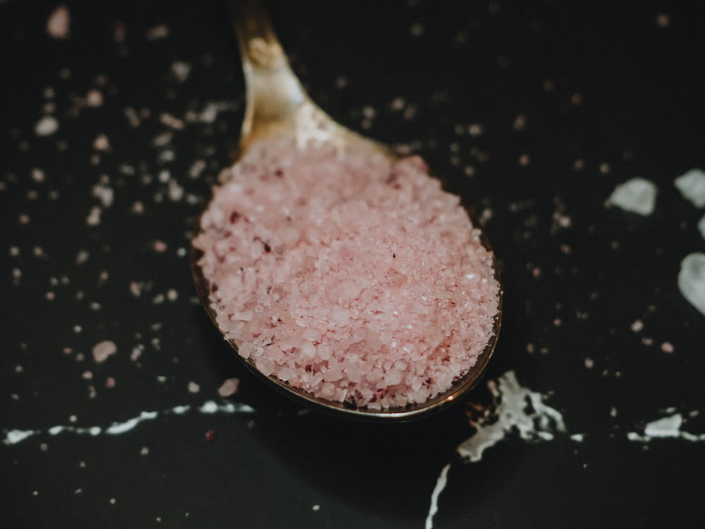 pink powder on black frying pan