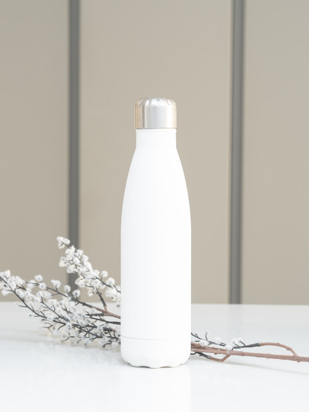 white bottle on white table