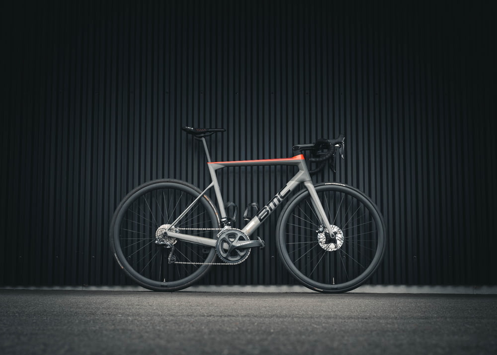 a bike parked in front of a black wall