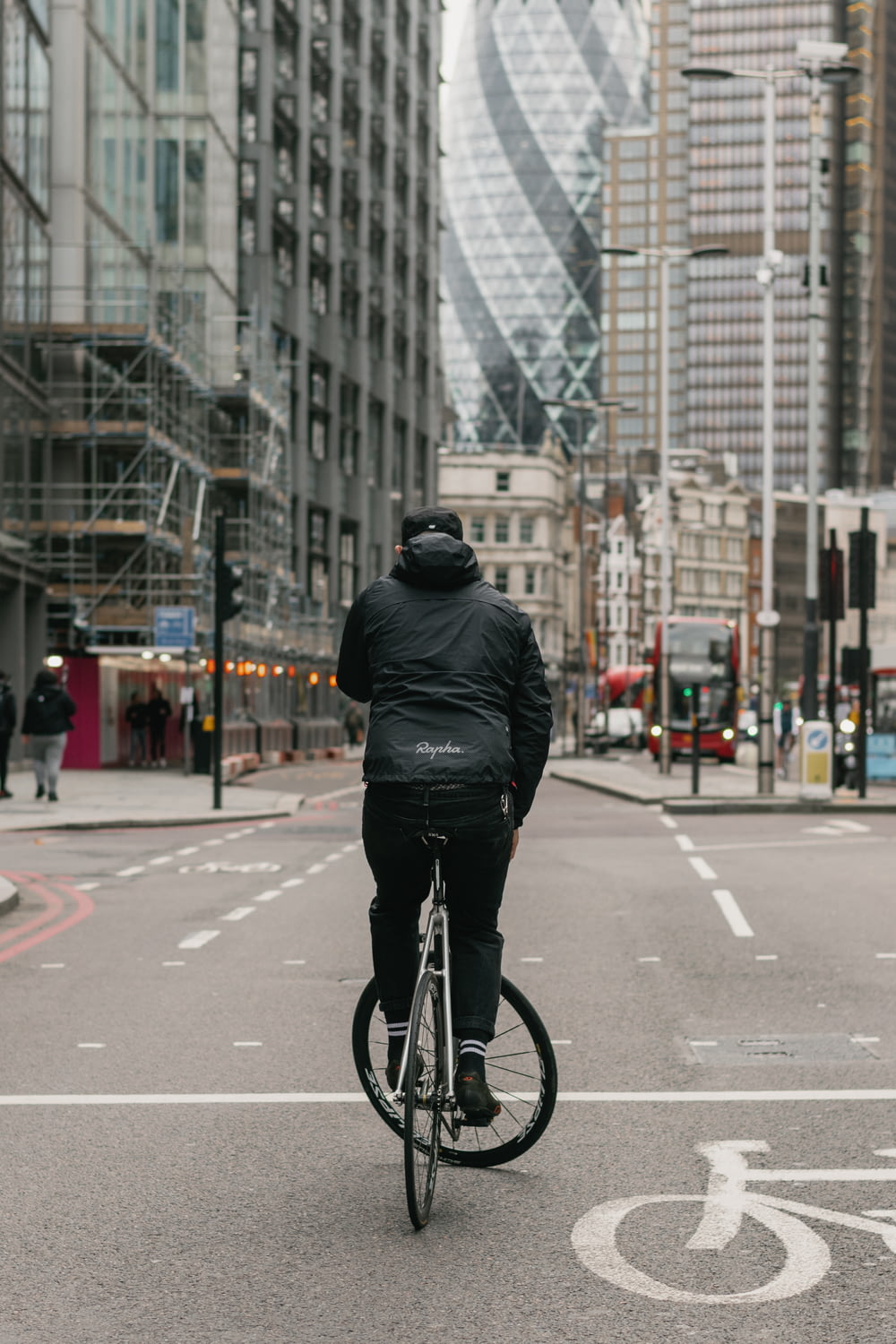 homme en veste en cuir noir faisant du vélo sur la route pendant la journée