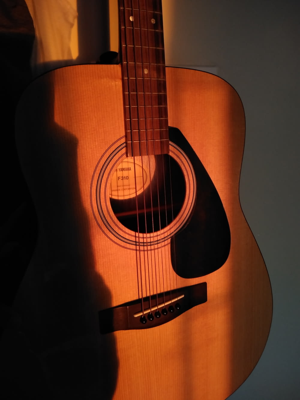 brown acoustic guitar on black background