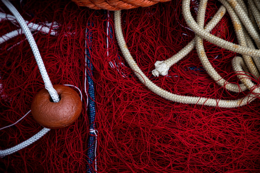brown rope on red textile