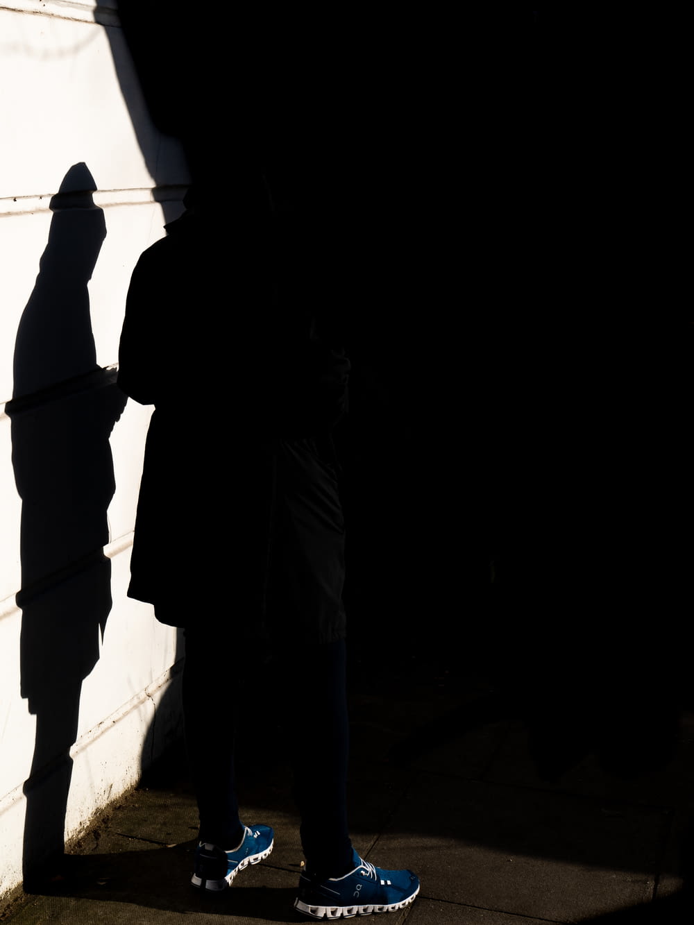 silhouette of person standing on hallway