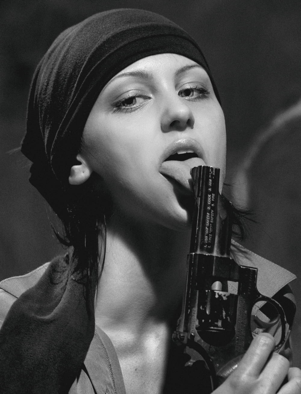 woman in black hijab holding black semi automatic pistol