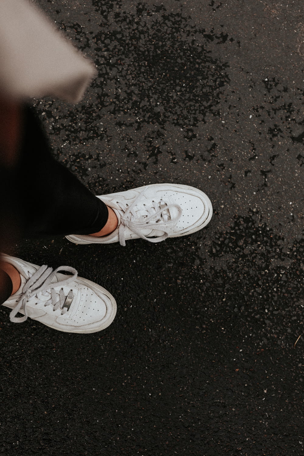 person wearing white nike sneakers