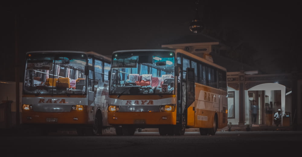 yellow and red bus on road during night time