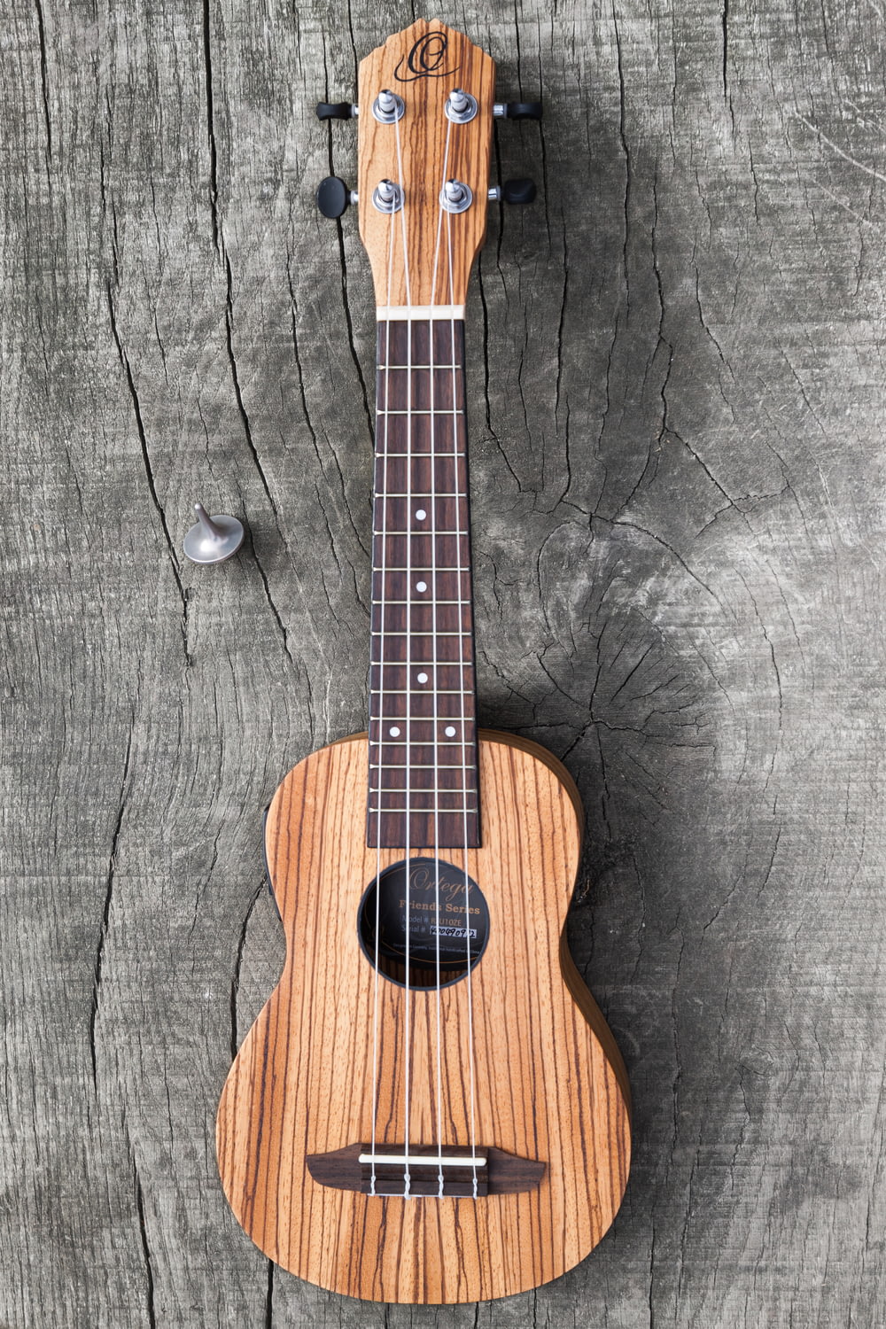 brown acoustic guitar on black textile