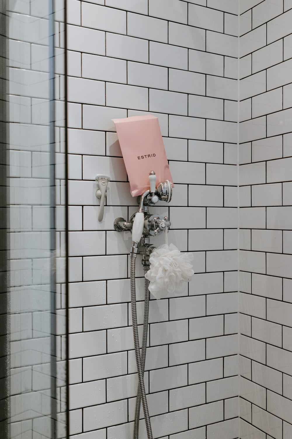 white shower head on white wall tiles