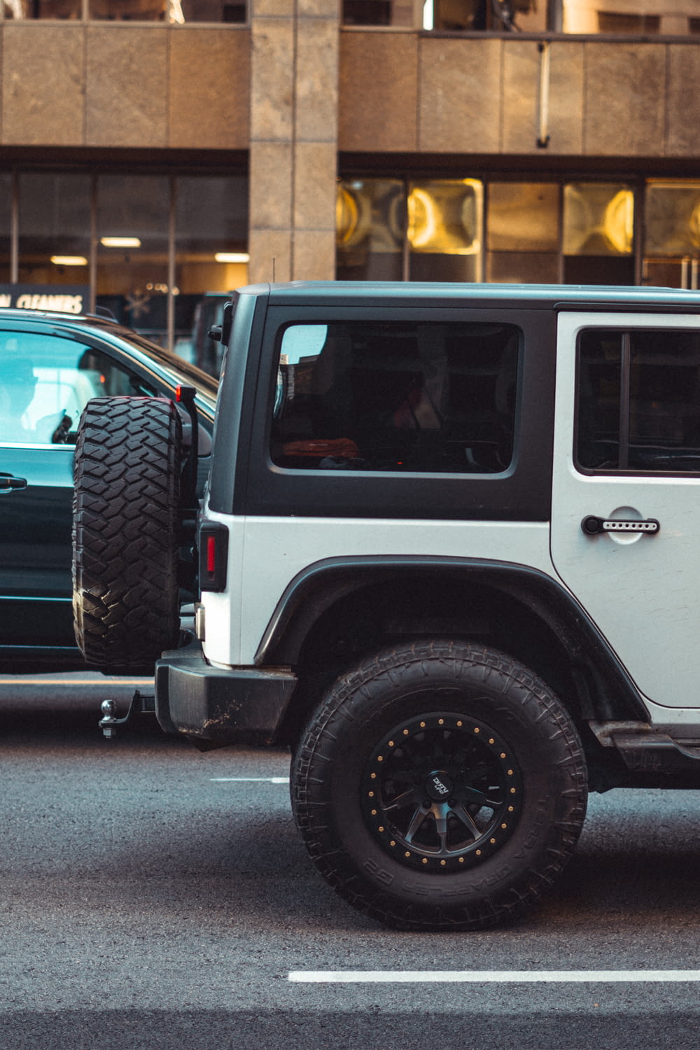 white and black jeep wrangler on road during daytime