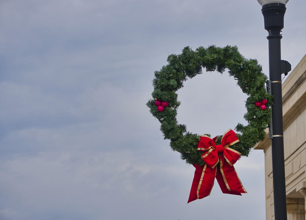 green and red wreath with red ribbon