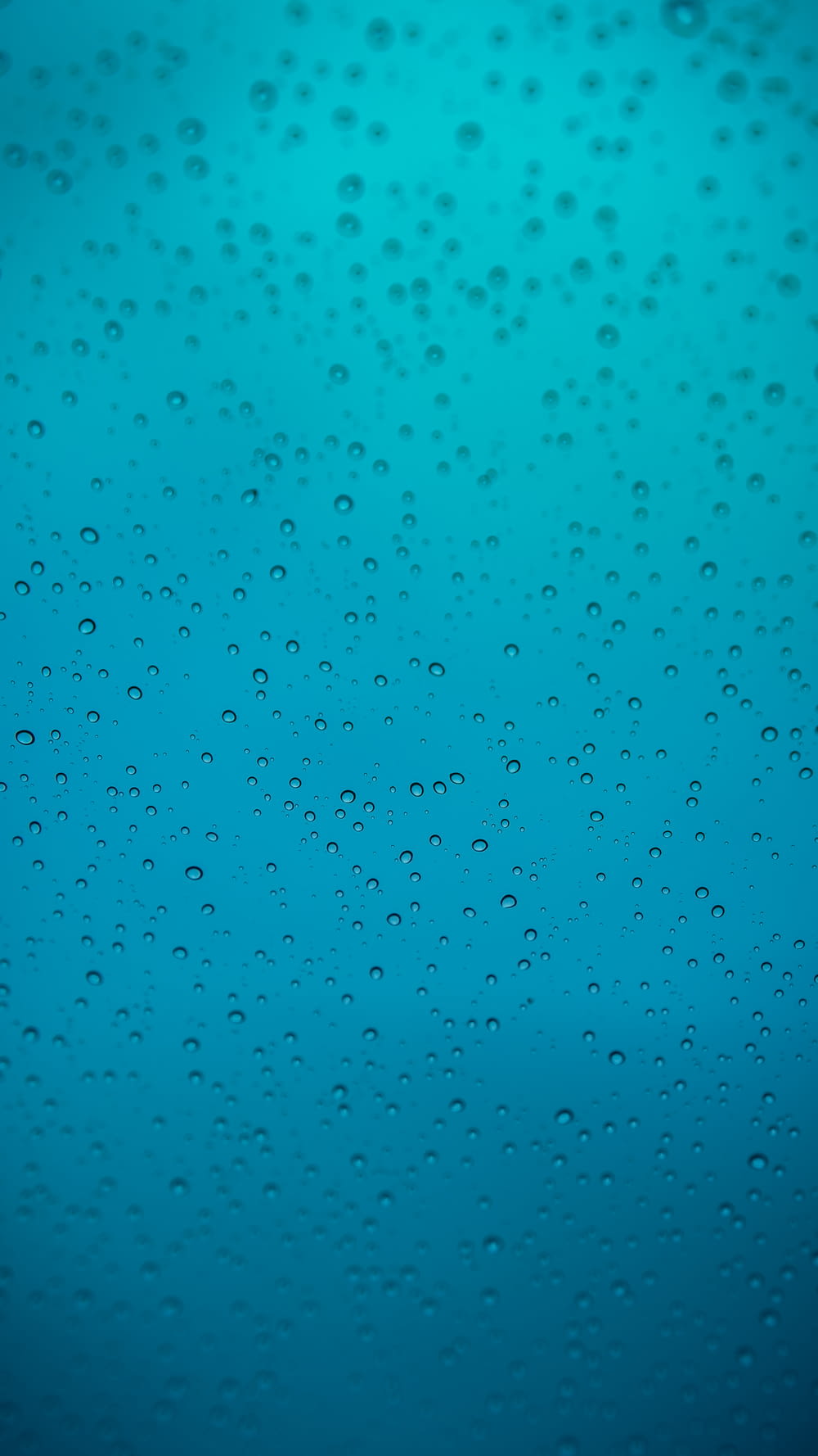 water droplets on teal surface