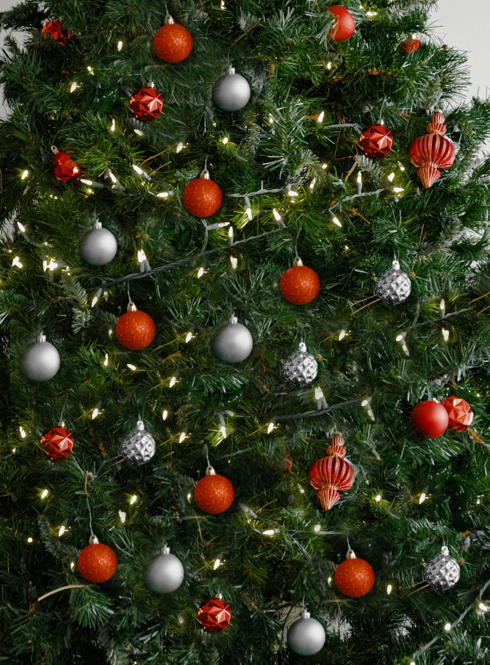 red and silver baubles on green christmas tree