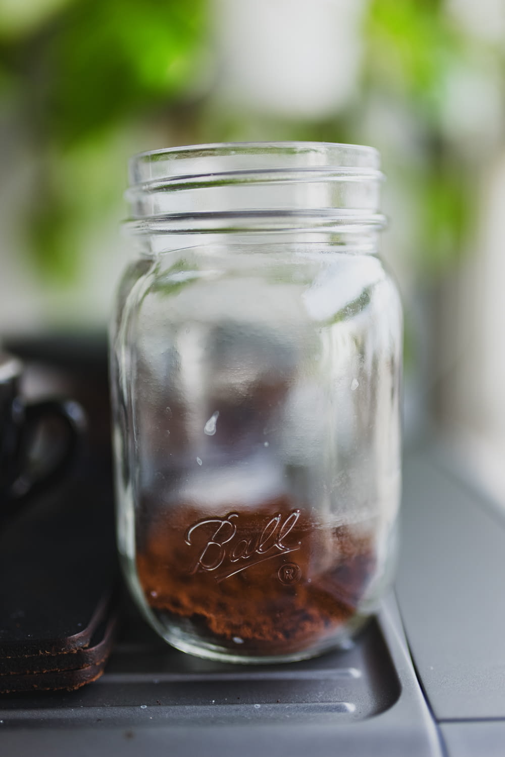 clear glass jar with brown liquid inside