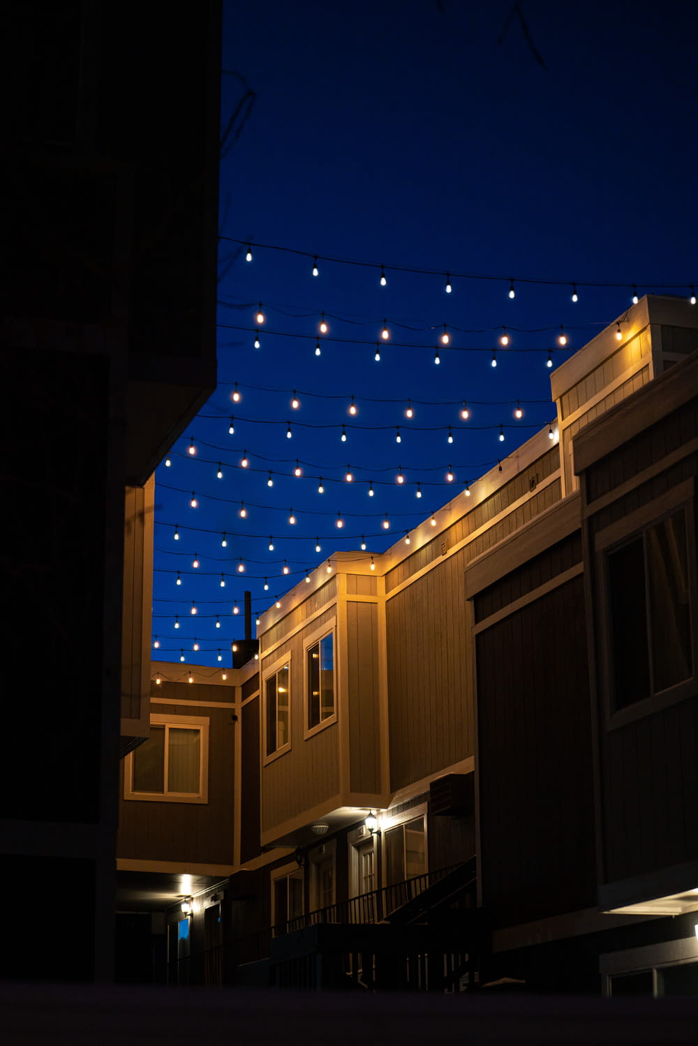 string lights on brown building during night time