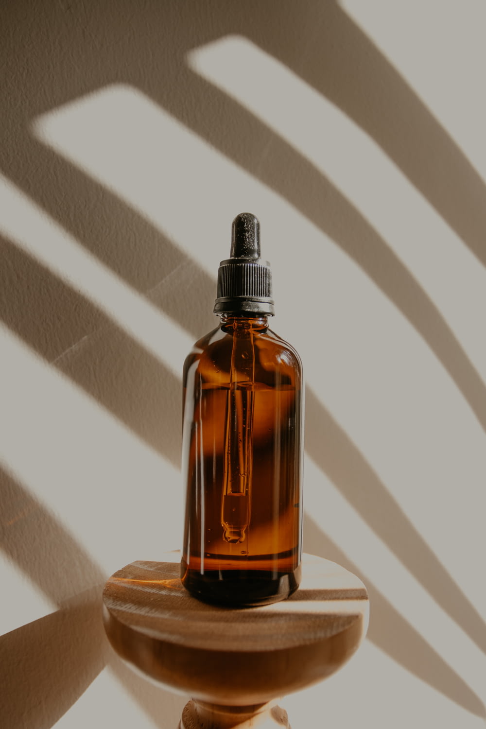 clear glass bottle on brown wooden table