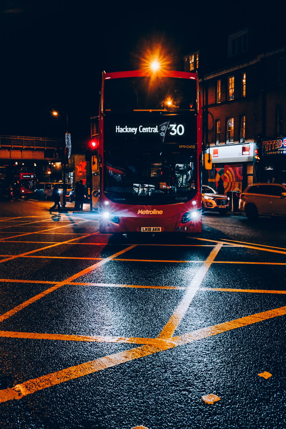 red and black double decker bus on road during night time