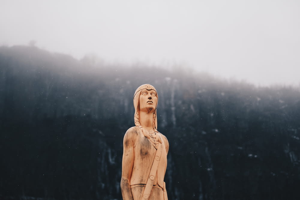 woman in brown coat statue