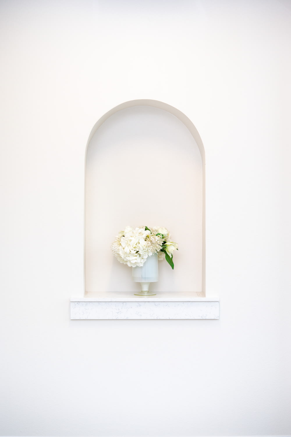 white flower bouquet on white ceramic vase
