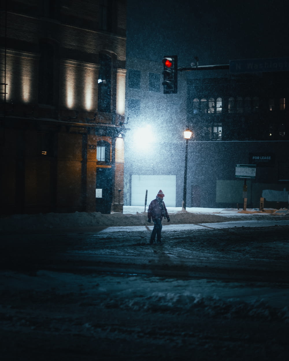person walking on street during night time