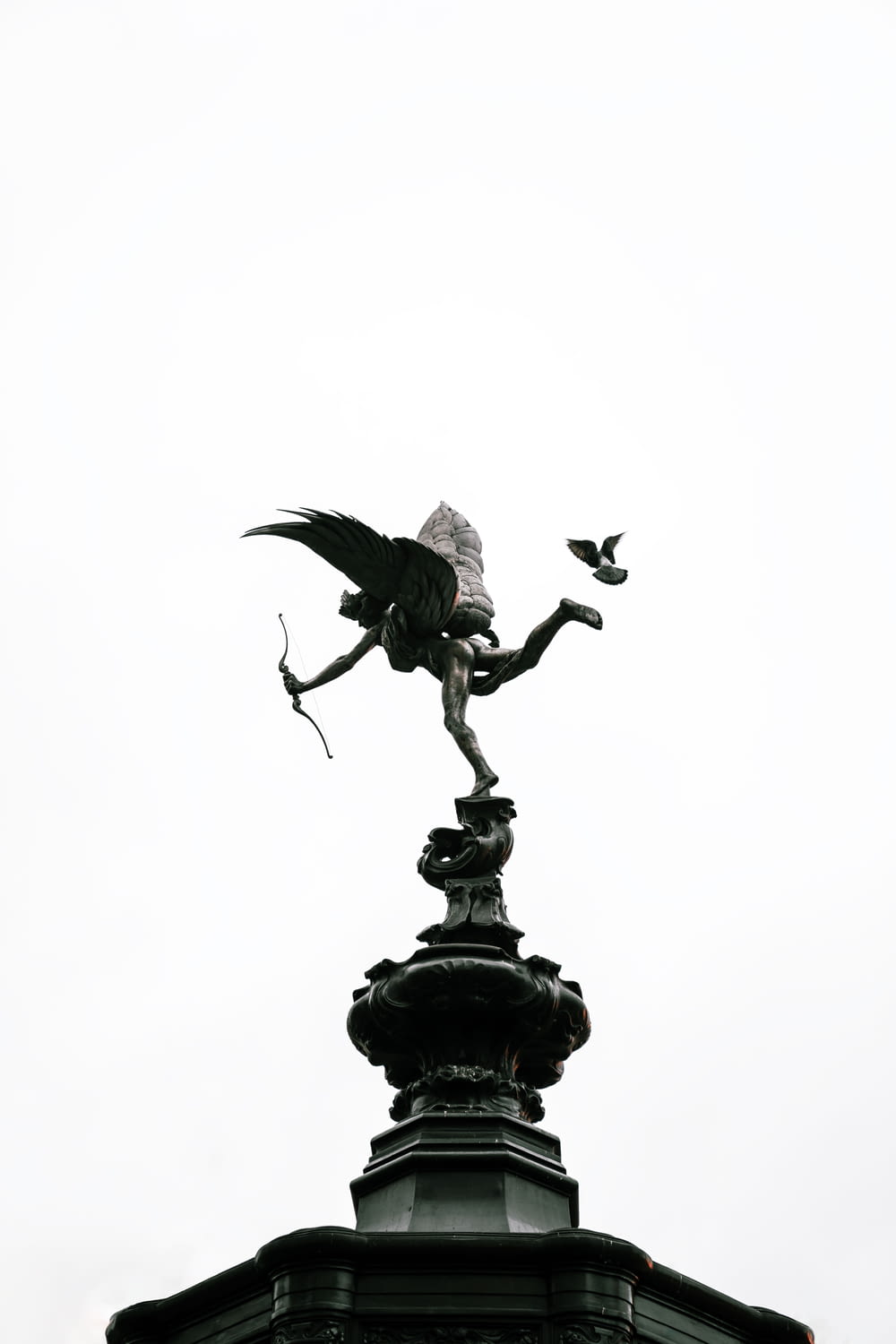 black bird statue under white sky during daytime
