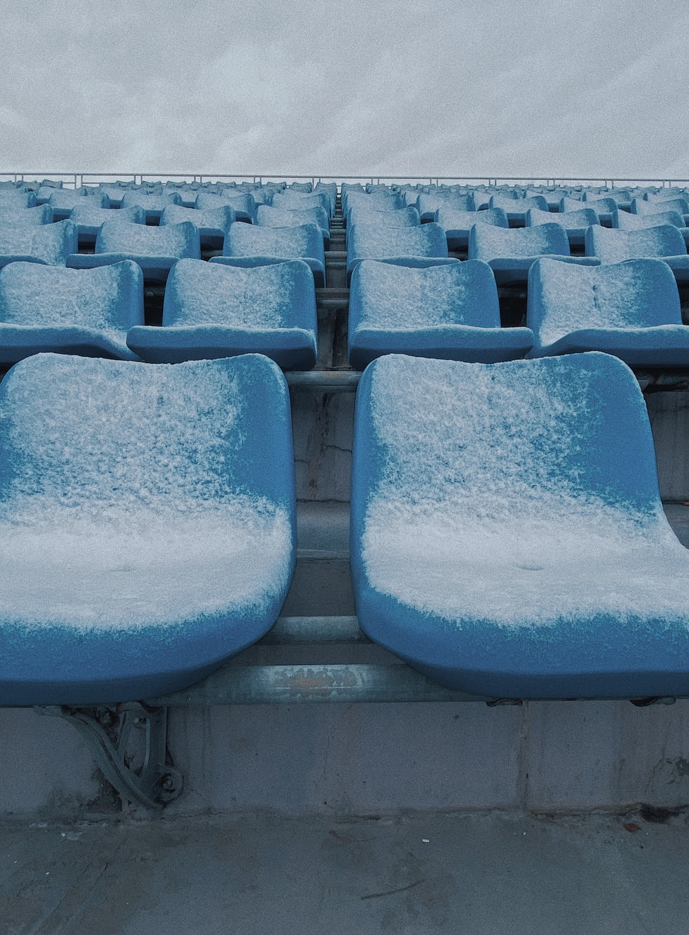 blue snow covered chairs during daytime