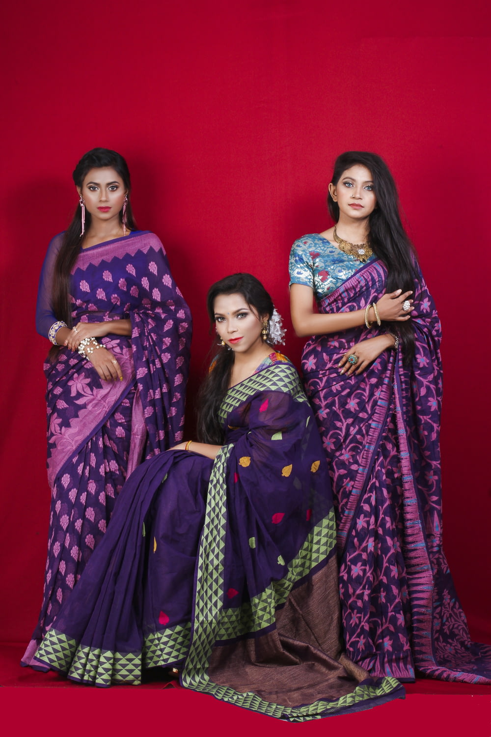 3 women in purple and pink sari