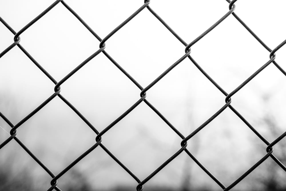 grayscale photo of chain link fence